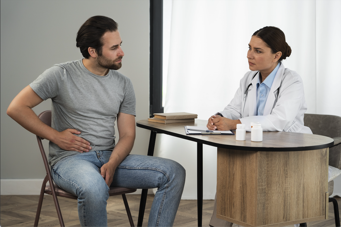 Man in pain consulting with stomach doctor